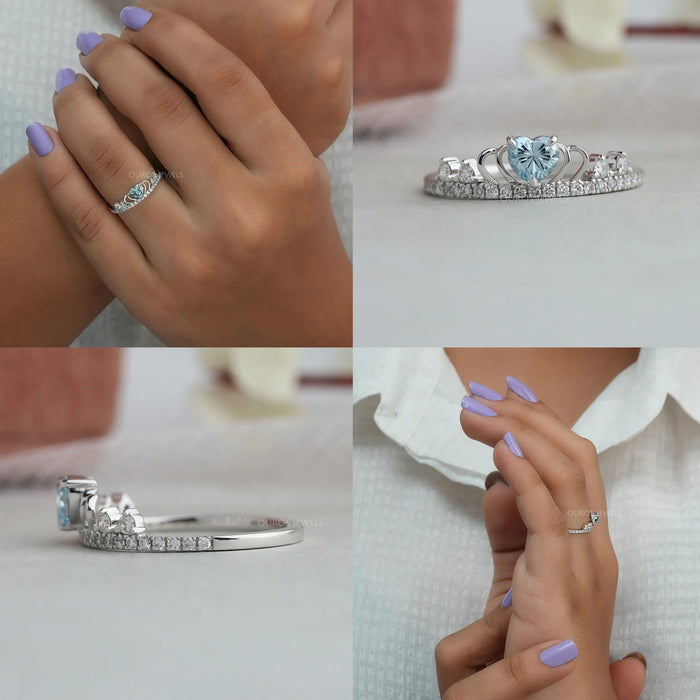 This elegant ring features a deep blue heart-shaped diamond that is surrounded by dazzling white diamonds in a crown-like setting which adds to its regal charm
