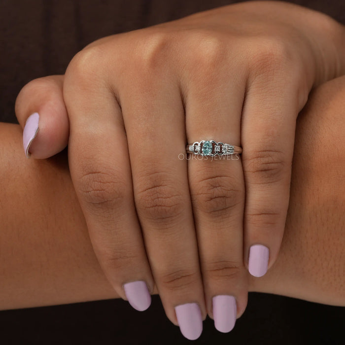 In finger look of green oval shaped lab created diamond engagement ring