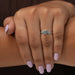 In finger look of green oval shaped lab created diamond engagement ring