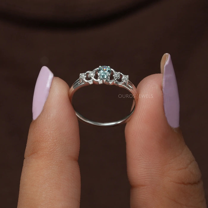 A close up look of lab diamond engagement ring with brilliant oval and round diamonds