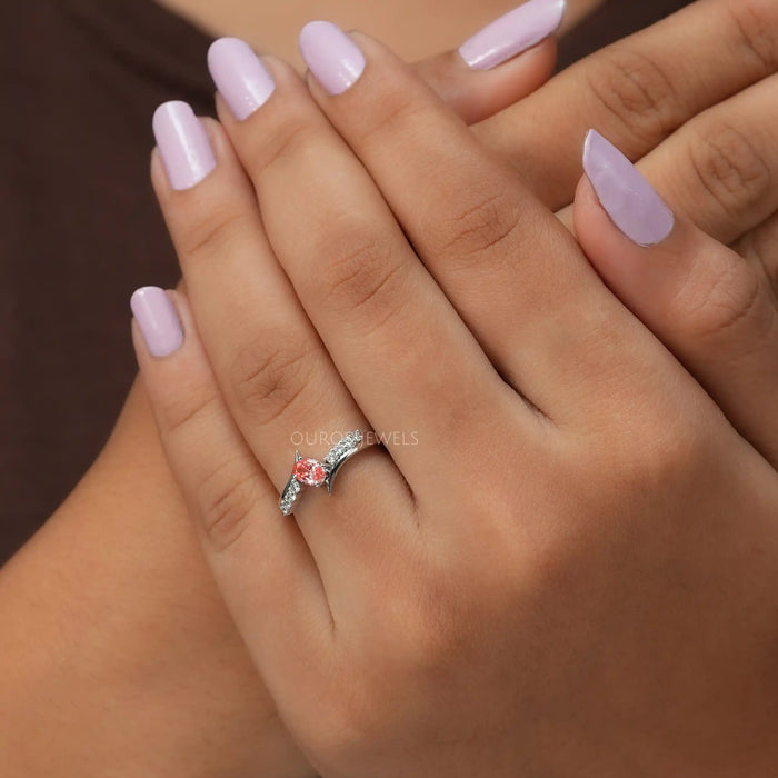 Cross hand front finger view of oval cut diamond engagement ring in 14k white gold.