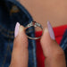 In two finger front view of cushion shaped cluster diamond ring in 14k white gold. Best choice for to gift someone.