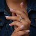 In finger side look of oval brilliant cut lab made diamond engagement ring