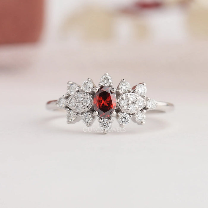 Oval red diamond ring with cluster setting in solid gold