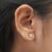 Dazzling yellow cushion diamond earrings shining brilliantly in the light with their unique and vibrant hue